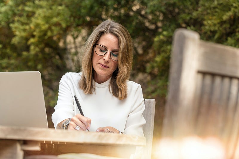 Woman writing her plans at a table