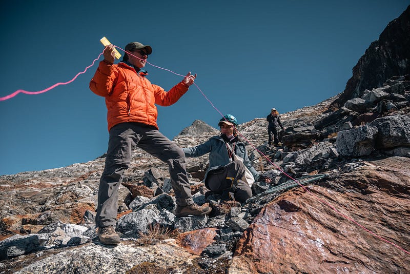 Scientists working with a thermal blanket on La Corona glacier